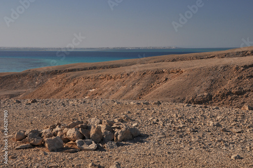 Desert island landscape panorama in the Red Sea. On the horizon is the coastline of Hurghada.