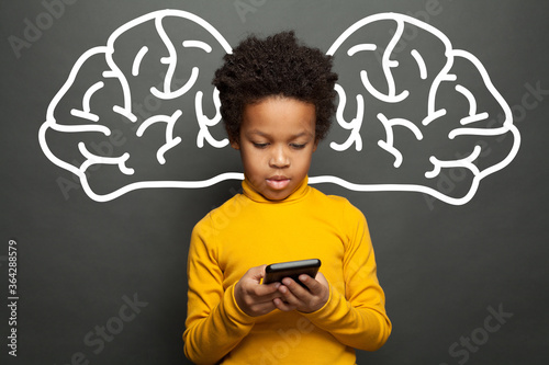 Thinking smart black child using smartphone, brainstorming and technology concept