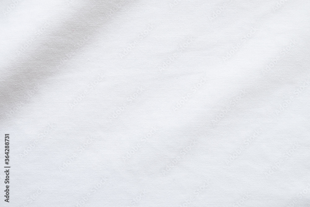 Top view close up shot of white fabric cotton shirt with woven gradient detail. Background and wallpaper concept. Top view close up shot of white fabric cotton shirt with woven gradient detail. Background and wallpaper concept.