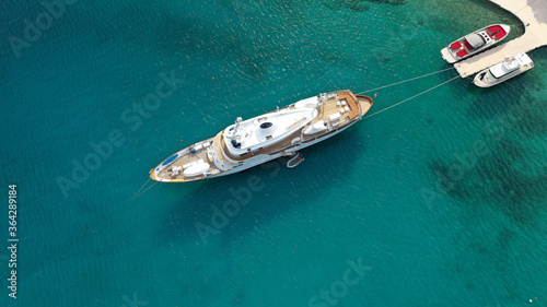 Aerial drone photo of yacht - boat with wooden deck anchored in tropical exotic paradise with turquoise open sea © aerial-drone