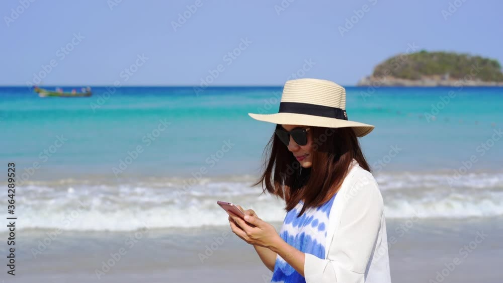 Young asian woman traveler using her smartphone at tropical sand beach, Summer vacation concept
Young asian woman traveler using her smartphone at tropical sand beach, Summer vacation concept