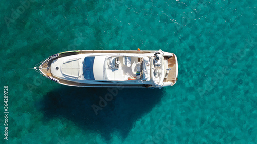 Aerial drone photo of large yacht - boat anchored in tropical exotic paradise bay with emerald open ocean