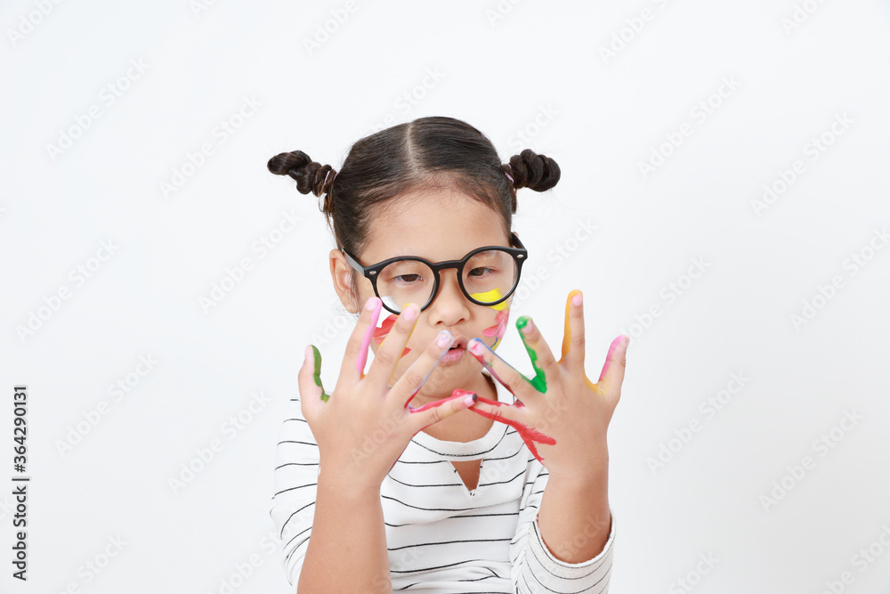 Beautiful Asian kid girl wearing glasses looking at fingers hands with painting watercolor. Beautiful Asian kid girl wearing glasses looking at fingers hands with painting watercolor.