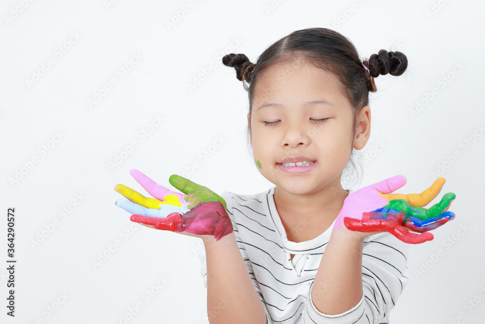 Portrait Asian kid girls standing eyes closed with painting color on hands isolated on white background with copy space. learning the art express the fun. Concept education, inspiration, and ideas. Portrait Asian kid girls standing eyes closed with painting color on hands isolated on white background with copy space. learning the art express the fun. Concept education, inspiration, and ideas.