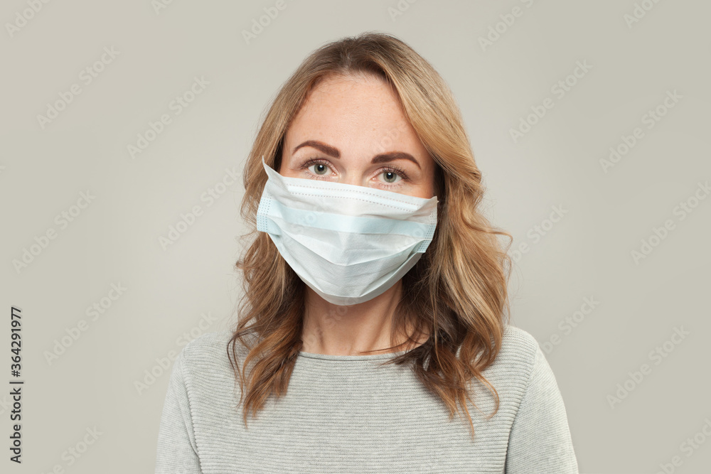 Casual woman in medical protective face mask on white Casual woman in medical protective face mask on white