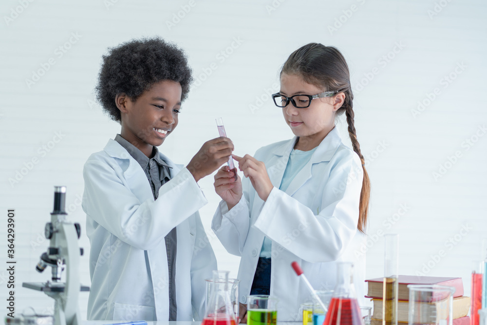 Two children scientists making experiments chemical in the laboratory room Two children scientists making experiments chemical in the laboratory room