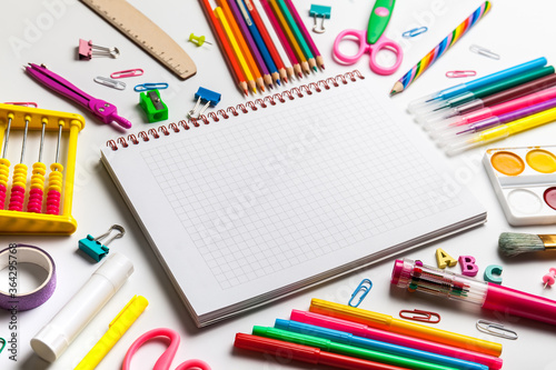Back to school concept. Open notebook with school supplies