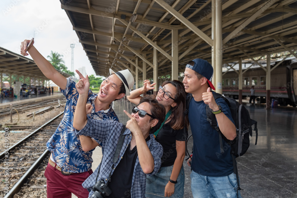 Fototapeta premium Concept life style holidays travel or journey : Young Asian tourists friend group Are using mobile phones for selfies at Train station area