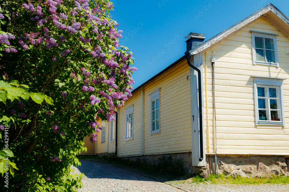 Beautiful street with old wooden houses and blooming lilac in old town of Porvoo Beautiful street with old wooden houses and blooming lilac in old town of Porvoo