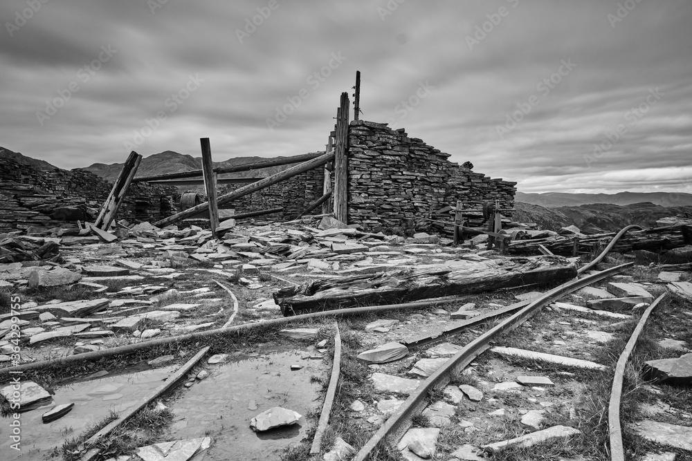 Abandoned copper mine workings above Coniston in the Lake District shot in black and white