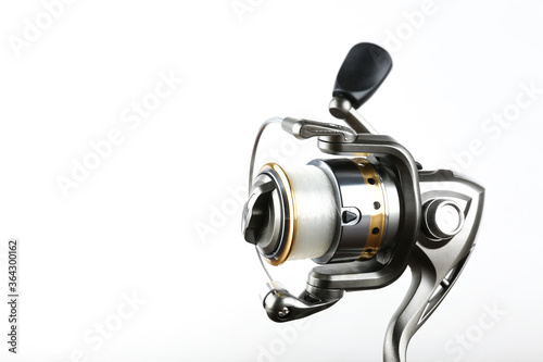 silver fishing reel on a white background with copy space