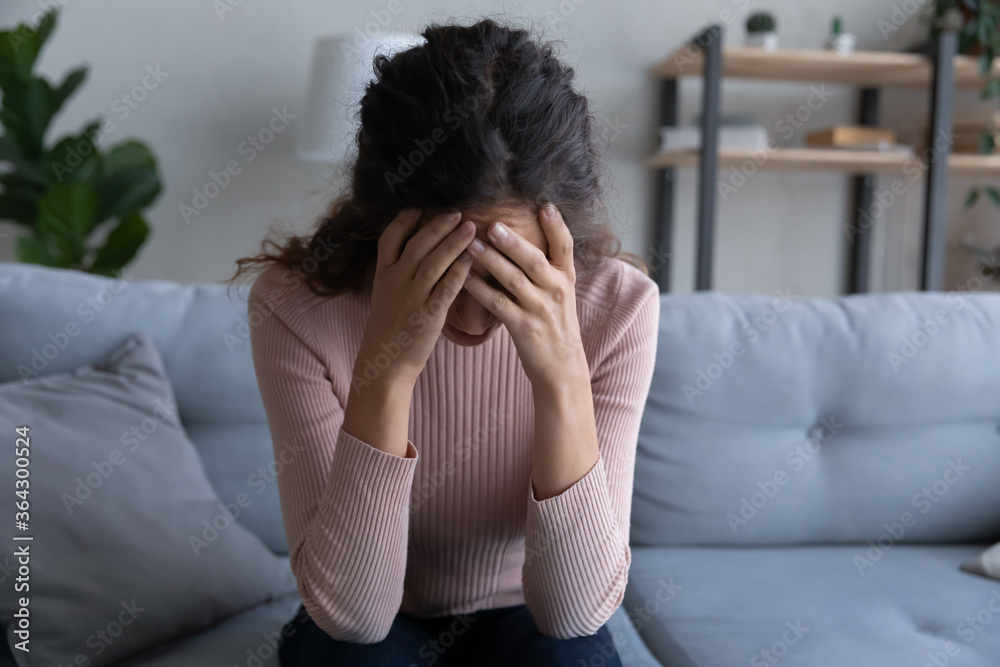 Unhappy young Caucasian woman sit on sofa at home stressed depressed about life relationships problems, upset millennial female feel lonely suffer from psychological mental troubles, need help Unhappy young Caucasian woman sit on sofa at home stressed depressed about life relationships problems, upset millennial female feel lonely suffer from psychological mental troubles, need help