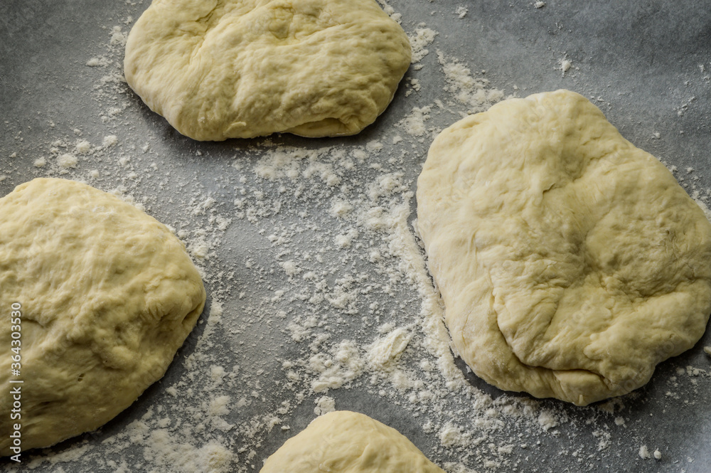 Raw little focaccia dough balls ready to be backed. Traditional Italian Focaccia homemade flat bread focaccia. Raw little focaccia dough balls ready to be backed. Traditional Italian Focaccia homemade flat bread focaccia.