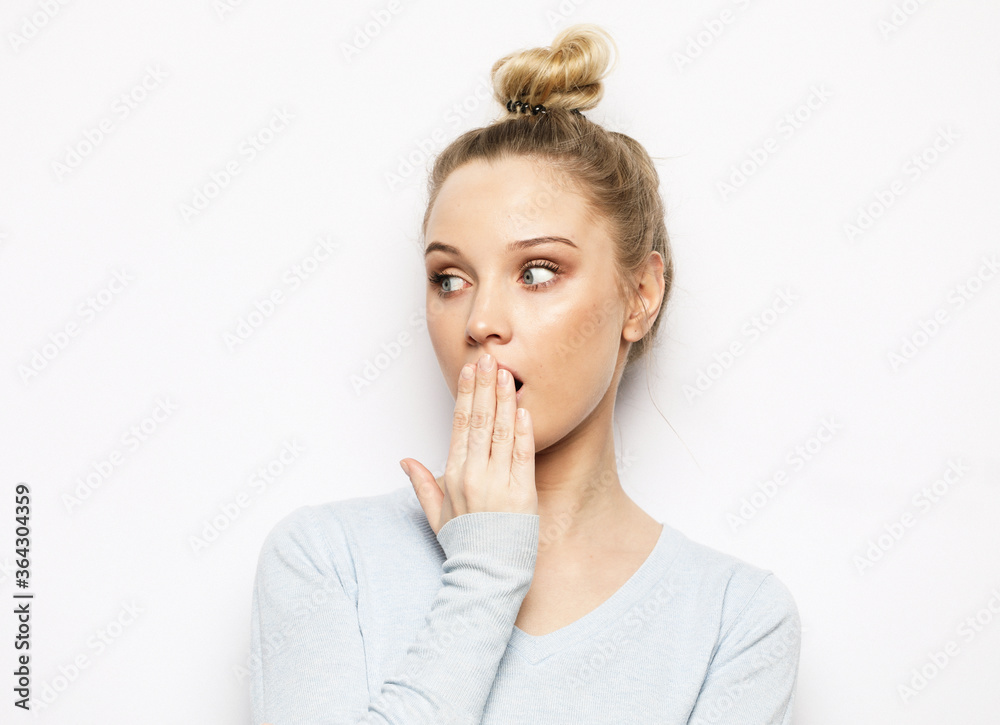 shocked blonde woman keeps mouth widely opened, looks at camera, wears casual clothes shocked blonde woman keeps mouth widely opened, looks at camera, wears casual clothes