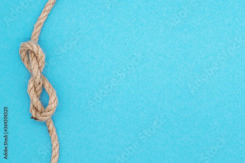 Summer nautical composition, bright background with rope nodal knot