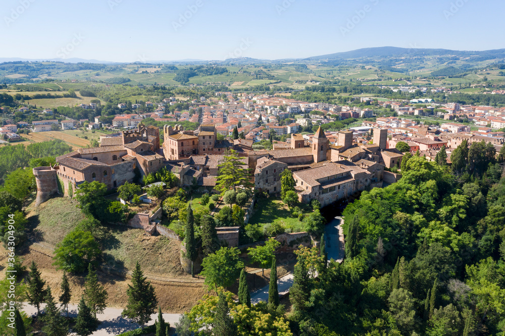 aerial view of the medieval town of Certaldo with visible in the background the town of San Gimignano on the hills of tuscany