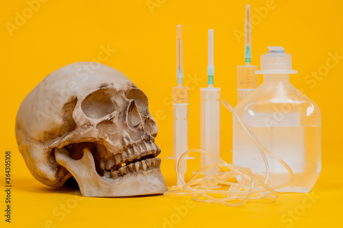 Human skull next to a dropp...