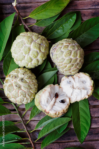 4 custard apple lay on the leaves, one of which saw the seed photo