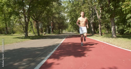 Wallpaper Mural Blonde male athlete running sprint train on athletics track.Fit, strong legs. Marathon runner in intense sprint exercise. Torontodigital.ca