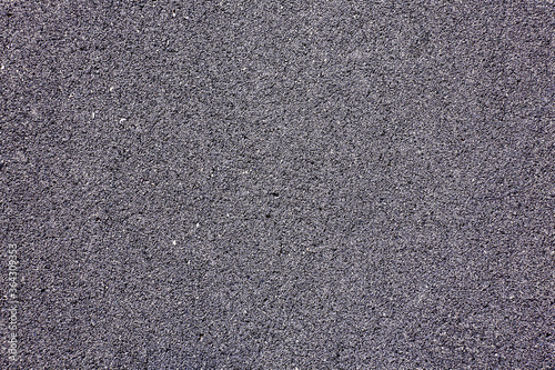 A full-frame Shot of an Empty Road, smooth, fine-grained asphalt with a blue tint.