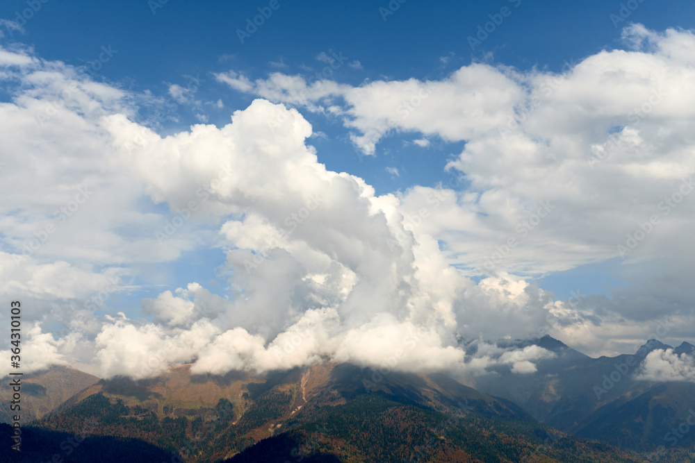 Nature and travel concept - High mountain and sky with clouds in autumn. Beautiful landscape..