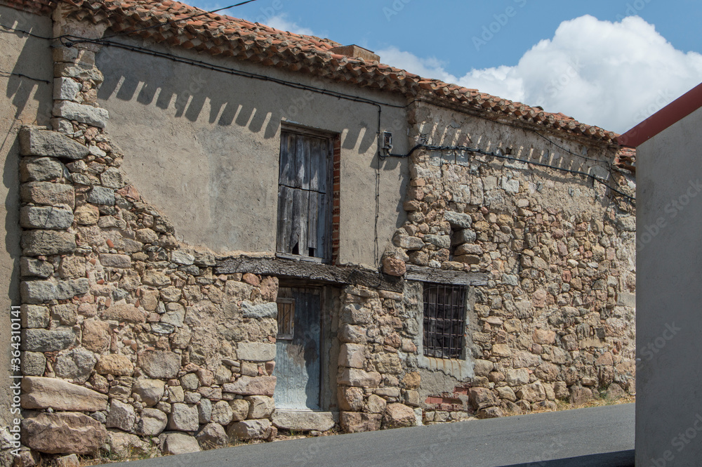 old abandoned rural house in with wooden door and windows in street in Las Navas del Marques, province od Avila. Spain old abandoned rural house in with wooden door and windows in street in Las Navas del Marques, province od Avila. Spain
