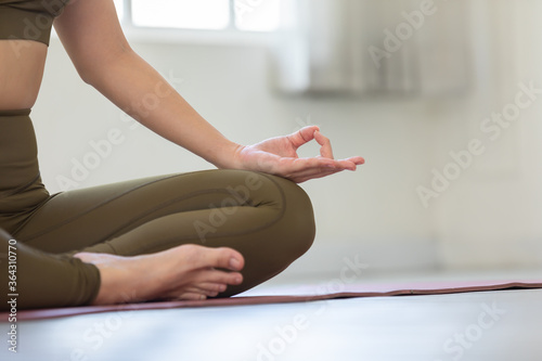 Close up hands woman doing yoga lotus pose at home calm and happiness