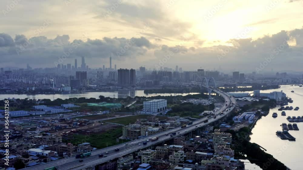 South west boundary of Guangzhou megapolis city, with highways and river ships navigating in Pearl river. Early morning. Sunrise. South west boundary of Guangzhou megapolis city, with highways and river ships navigating in Pearl river. Early morning. Sunrise.