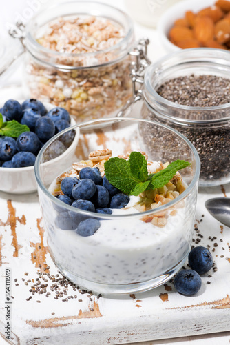 healthy breakfast with chia-pudding and fresh blueberries, top view