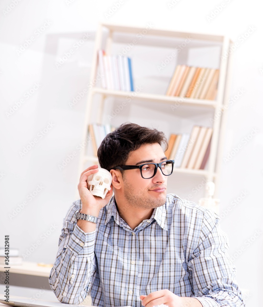 Medical student studing the skeleton Medical student studing the skeleton