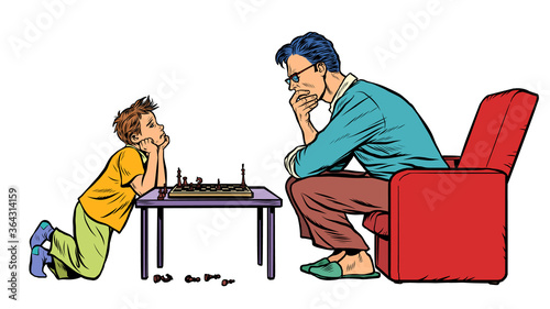 father and son play chess