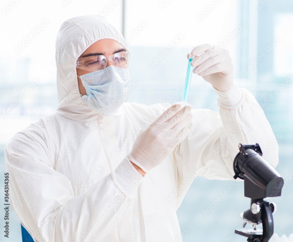 Fototapeta premium Young chemist student working in lab on chemicals