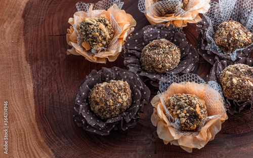 Photography Dark vegan chocolate candies with party background