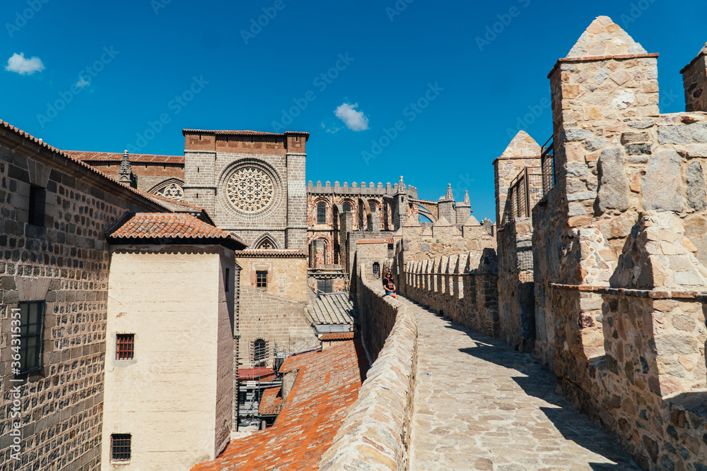 Woman tourist walks on the fortress of the city of Avila in Spain