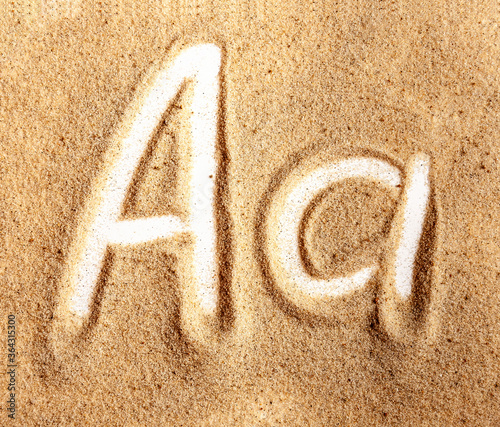 Letter A. English Handwritten Alphabet In The Sand photo