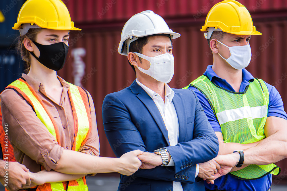 Engineer team people standing with their hands together at the container yard with oil and gas refinery background. Cargo freight ship for import and export. Team Teamwork Concept Engineer team people standing with their hands together at the container yard with oil and gas refinery background. Cargo freight ship for import and export. Team Teamwork Concept