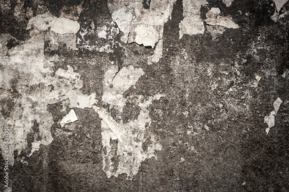 old cracked bulletin board wall with rests of paper