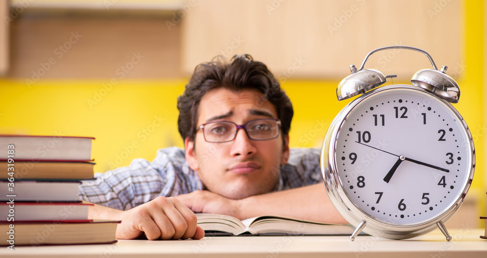 Student preparing for exam sitting at the kitchen Student preparing for exam sitting at the kitchen