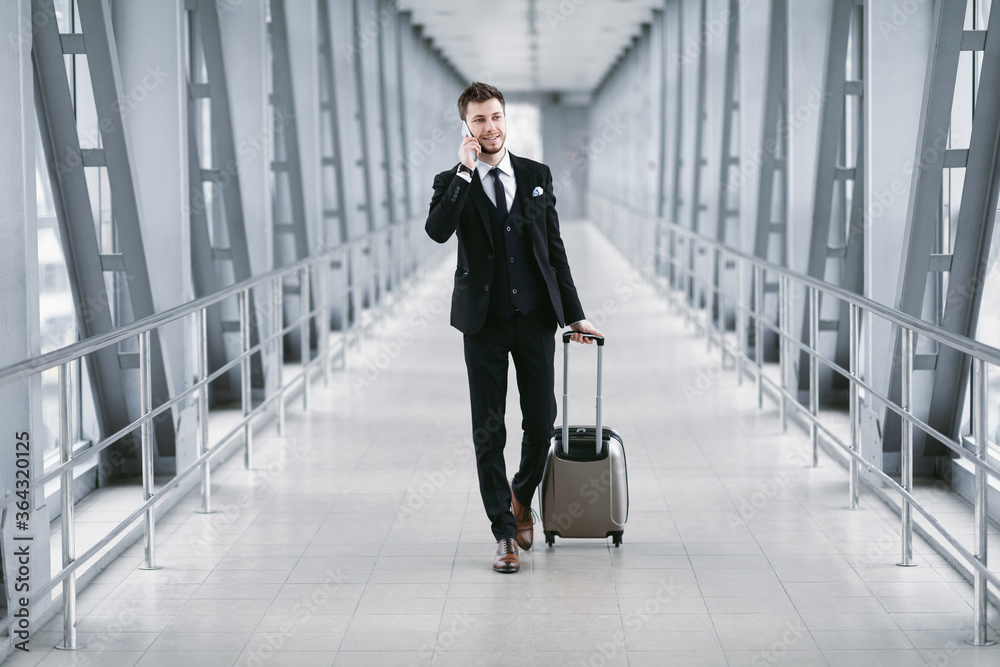 Urban business man talking on smartphone in airport