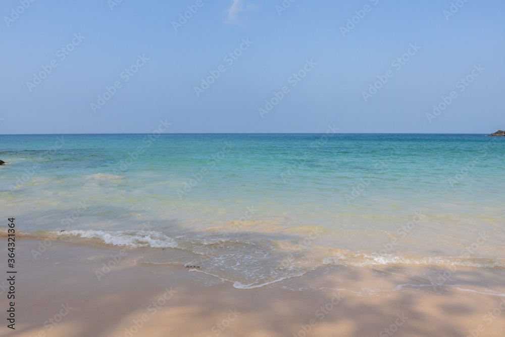Tropical beach with white sand and blue water.