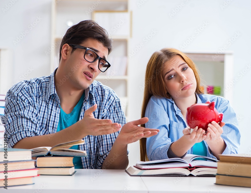Fototapeta premium Two students checking savings to pay for education