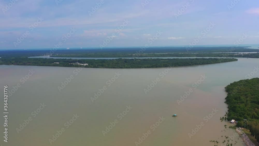 Aerial view over the Klang delta, near the Port of Klang, Malaysia. Small islands in the Strait of Malacca, at the shore of west Malaysia. industrial plants next to untouched wildlife habitat. Aerial view over the Klang delta, near the Port of Klang, Malaysia. Small islands in the Strait of Malacca, at the shore of west Malaysia. industrial plants next to untouched wildlife habitat.