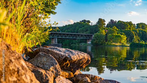 Sonnenuntergang an der Donau bei Regensburg mit Blick auf eine alte Eisenbahnbrücke