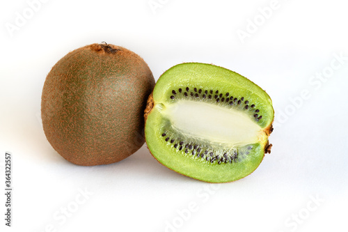 Whole and half-sliced kiwi on a white background