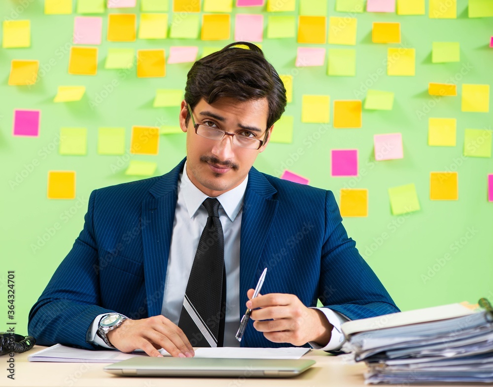 Businessman having trouble with his priorities Businessman having trouble with his priorities