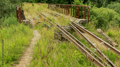 an old and broken overgrown railway