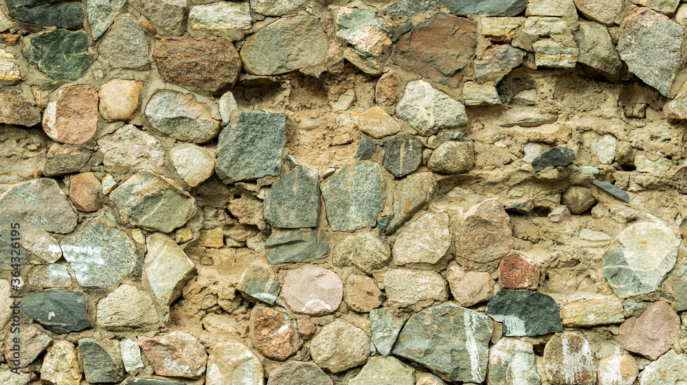 Fototapeta premium Wall of oval stones, backgrounds, textures