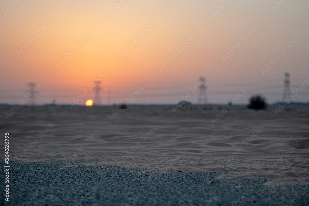 Obraz premium High voltage power lines in the desert during sunset
