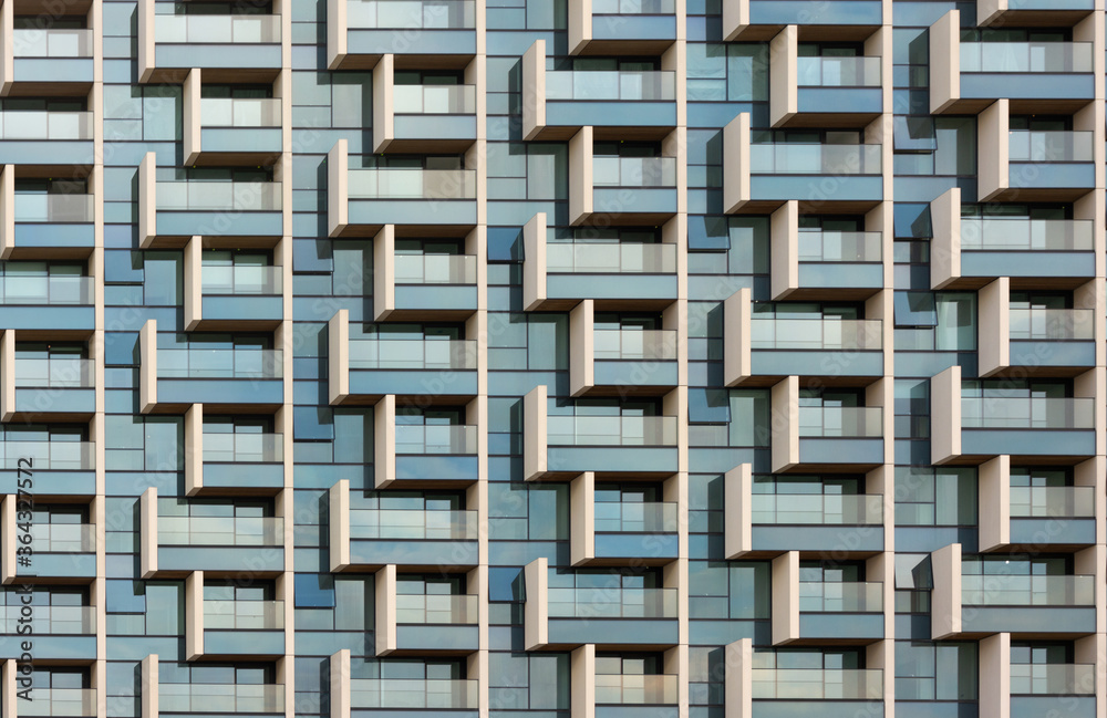 Windows and balconies (of flats / apartments) forming an abstract geometric pattern.