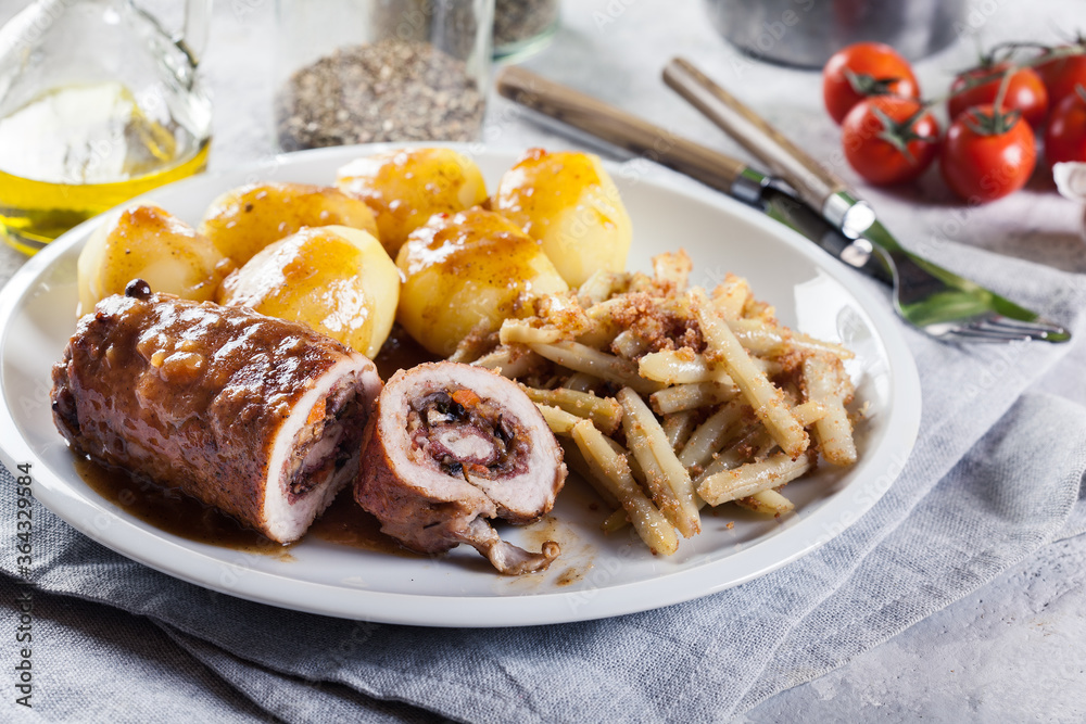 Pork rolls stuffed with vegetables served with potatoes